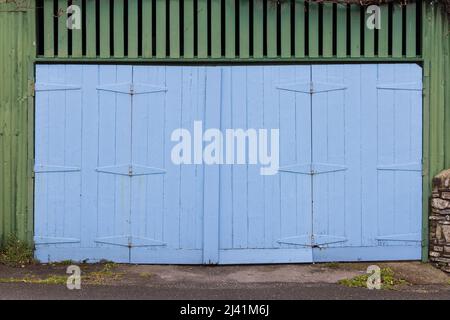 Old blue wooden painted garage doors. Stock Photo
