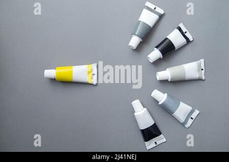 Tubes of acrylic paint in different colors, flat lay. Stock Photo