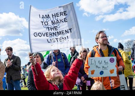 Extinction Rebellion protesters launching period of civil disruption in London from 9 April 2022. Child with banner, asking the government to listen Stock Photo