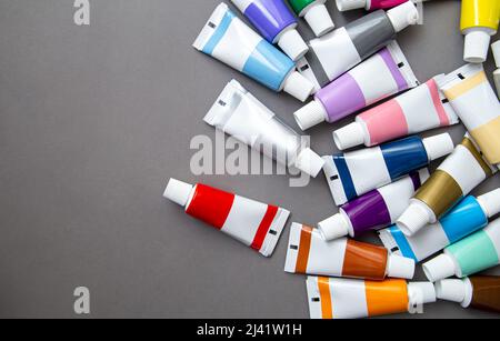 Tubes of acrylic paint in different colors, flat lay. Stock Photo