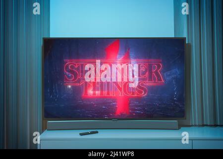 Stranger Thins season 4 TV series on big tv screen. Stranger things television show at home Stock Photo