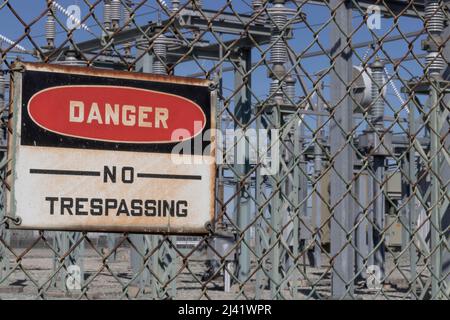 DANGER - NO TRESPASSING sign at an electrical substation. Stock Photo