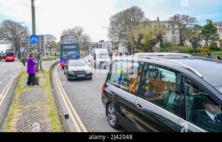 Brighton UK 11th April 2022 - The funeral procession for well known gay rights campaigner George Montague heads through Brighton today . George who was affectionately known as 'The Oldest Gay in the Village' died recently at the age of 98  : Credit Simon Dack / Alamy Live News Stock Photo