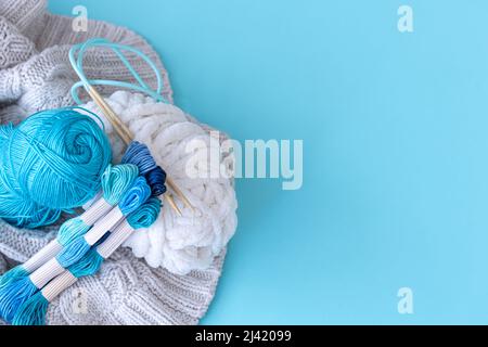 Threads of different colors on a blue background. Stock Photo