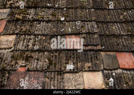 Ruined tiles on the old house. Stock Photo