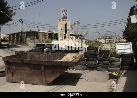 West bank, Palestine. April 11, 2022, Jenin, West bank, Palestine: A view of a barrier made of kushuk tires at the entrance to the Jenin refugee camp in the city of Jenin in the occupied West Bank, The Palestinians set up barriers made of kushuk tires at all entrances to the camp to prevent Israeli army vehicles from entering and storming it. (Credit Image: © Nasser Ishtayeh/ZUMA Press Wire) Credit: ZUMA Press, Inc./Alamy Live News Stock Photo