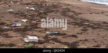 Garbage on the beach, world ocean pollution. Environmental pollution. Ecological problem. Dirty sea sandy shore. trash on the beach Stock Photo