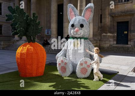 Paris, Paris, FRANCE. 11th Apr, 2022. A child plays around a big Easter bunny in front of the Ã‰glise Notre-Dame-de-l'Assomption in Paris, France. Christians around the world celebrate the resurrection of Jesus Christ on Sunday, April 17th and Monday 18th 2022. (Credit Image: © Remon Haazen/ZUMA Press Wire) Stock Photo