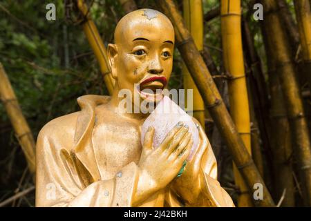 Beautiful unique buddha statue close shot. Golden religious sculpture representing a buddhist/monk. Ten Thousand Buddhas Monastery, Sha Tin, Hong Kong Stock Photo