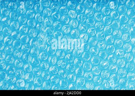 Packing bubble wrap for parcels on a blue background in full screen Stock Photo