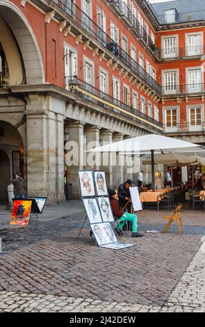 Local street artists display cartoons and pictures for tourist souvenirs in central Madrid, capital city of Spain Stock Photo