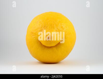 weird funny smiling lemon on neutral background Stock Photo