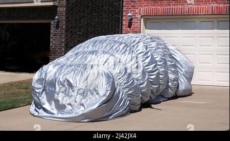 Parked car hail blanket cover protection. Stock Photo