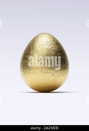 Chocolate easter egg with shiny gold foil on white background. Close-up. Stock Photo