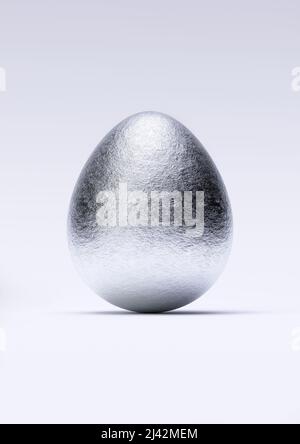 Chocolate easter egg with shiny silver Aluminium foil on white background. Close-up. Stock Photo