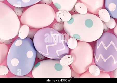 Group of pastel colored easter eggs on pink background Stock Photo