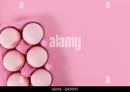 Easter eggs in box on pink background with copy space Stock Photo