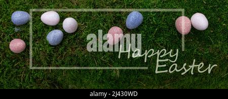 Happy Easter concept. Easter composition with colorful eggs on moss background. Celebration design. Banner. Stock Photo