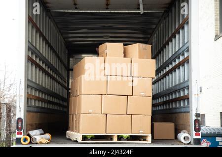 Open box truck with pallet of stacked cardboard boxes Stock Photo
