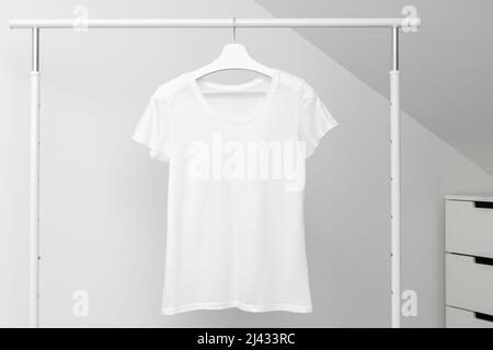 T-shirt hanging on Clothing rack. Round neck white color. Template, mock up Stock Photo