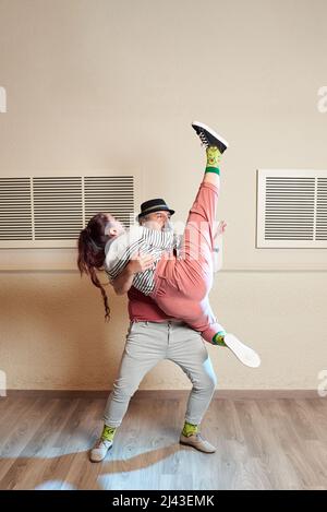 A man and a woman dancing Lindy Hop in a dance studio Stock Photo