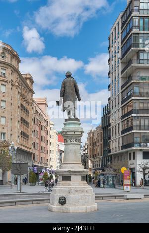 statue of Zorrilla on his pedestal with his back to the camera looking at the street of Santiago in the city of Valladolid, Castilla y Leon, Spain. Stock Photo