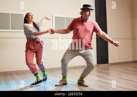 A man and a woman dancing Lindy Hop in a dance studio Stock Photo