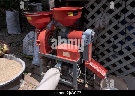 Mini electric rice milling machine Stock Photo