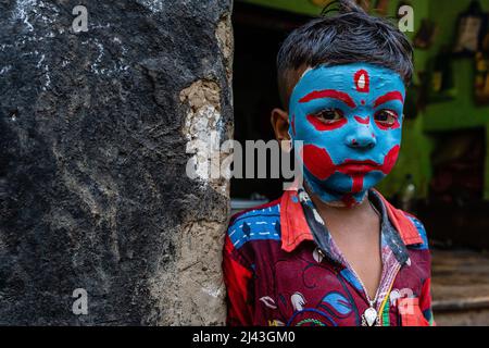 West Bengal, India. April 11, 2022, Bardhaman District, West Bengal, India: Face painting is a little part of the festival, here some village boy's faces are painted colorfully by an artist as they attend and celebrate the Bengali New Year festival called Pahela Boisakh in West Bengal state of India. Before the PahelaÂ Boishakh in Chaitra Sankranti some villagers celebrate the Gajan festival it is associated with gods as Shiva, Neel, and Dharmathakur. . Credit: ZUMA Press, Inc./Alamy Live News Stock Photo