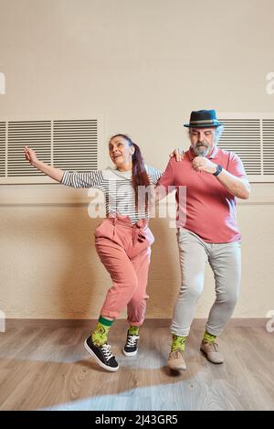 A man and a woman dancing Lindy Hop in a dance studio Stock Photo