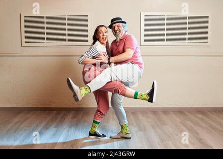 A man and a woman dancing Lindy Hop in a dance studio Stock Photo