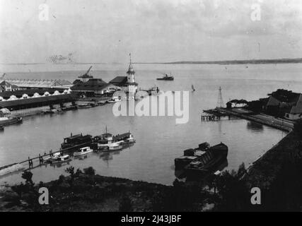East Java - Soerabaja - View of anchorage of Perak with Madoera in background. Harbour office in central Source: S.M. Herald. Surabaya Bombed by Japanese - ***** of the Netherlands East Indies, which has been considerably ***** raids. Top: Modern shops in Toendjoengan, the main *****, which was hit by a bomb. Lower: Portion of ***** the harbour. February 06, 1942. Stock Photo