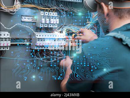 Electrician performing wiring in distribution board Stock Photo