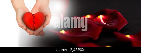 Cupped hands holding a broken heart and burning rose petals with copy space on black background Stock Photo