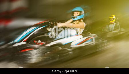 Female driving go-kart car indoor Stock Photo