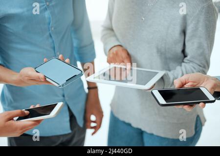 Well, we made some friends. Cropped shot of a group of unrecignizable businesspeople using their smart phones. Stock Photo