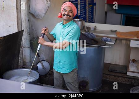 Portrait of a happy man cooking rice in restaurant Stock Photo