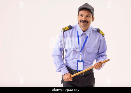 Security guard monitoring with a stick in his hand Stock Photo