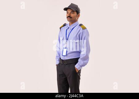 Portrait of Security guard looking elsewhere with hands in pockets Stock Photo