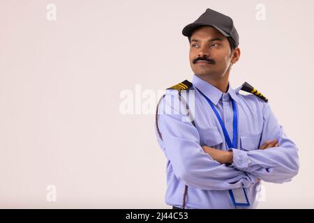 Portrait of Security guard looking elsewhere with arms folded Stock Photo