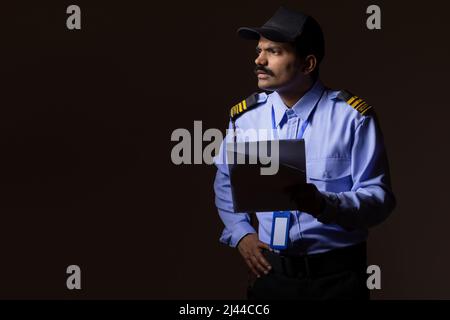 Security guard observing away while working at night Stock Photo