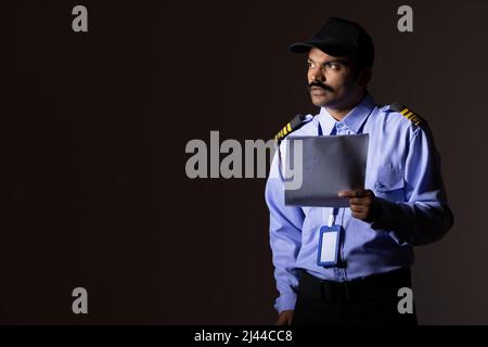 Security guard observing away while working at night Stock Photo