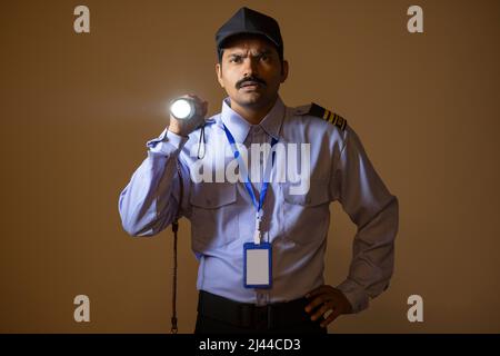 Security guard searching with torch light while working at night Stock Photo