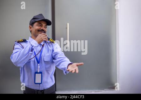 Portrait of security guard gesturing with his palm Stock Photo