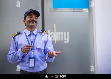 Portrait of security guard gesturing with his palm Stock Photo