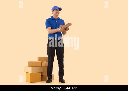 Portrait of a courier delivery boy writing on clipboard Stock Photo