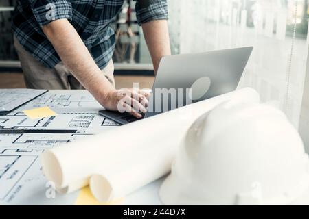 Architect working new project and using laptop with in office. Stock Photo