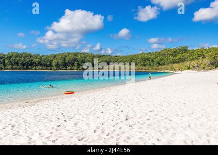 Tourists enjoying the crystal clear water at Lake McKenzie on Fraser Island in Queensland, Australia Stock Photo