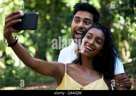 Youre my kind of person. Shot of a young couple taking a selfie while out on a date. Stock Photo