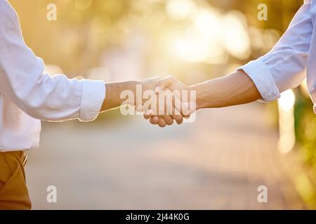 Youve got yourself a deal. Cropped shot of two unrecognizable businessmen standing in the city together and shaking hands. Stock Photo